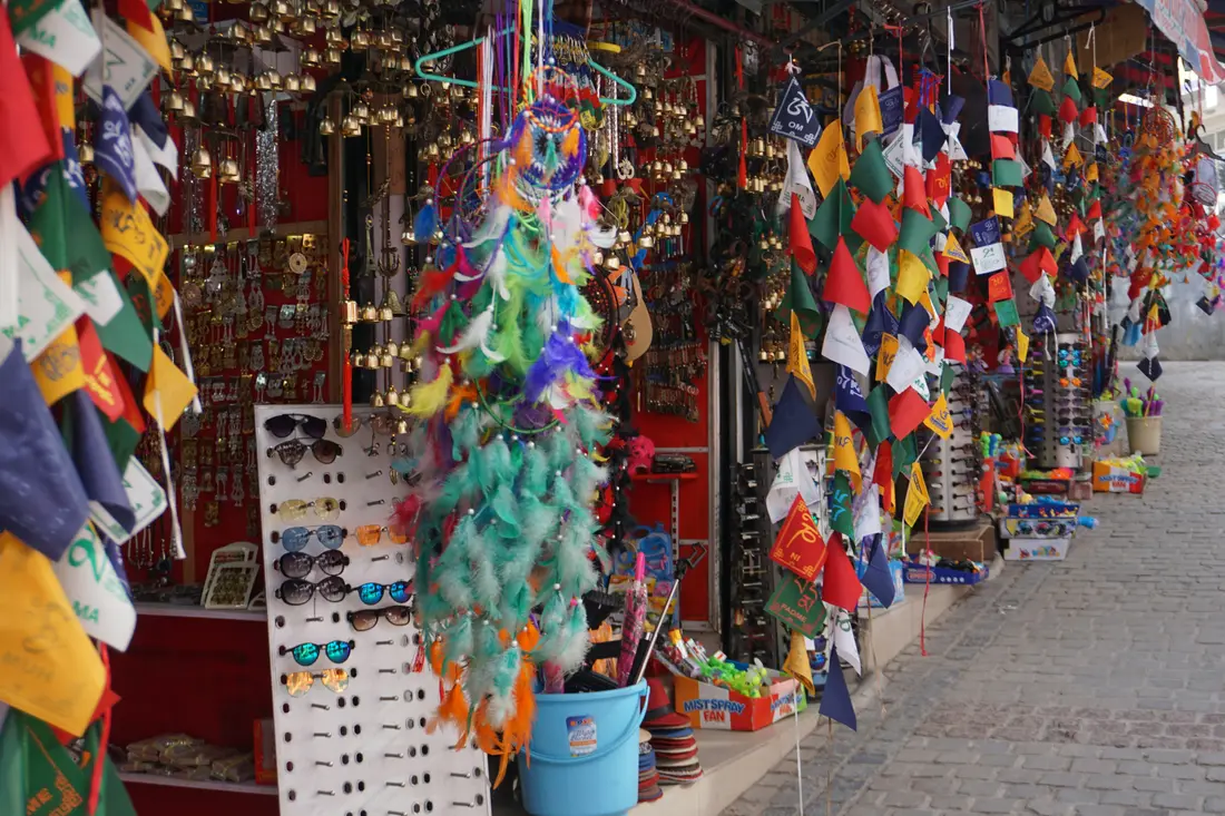 Colourful market stalls hung with prayer flags