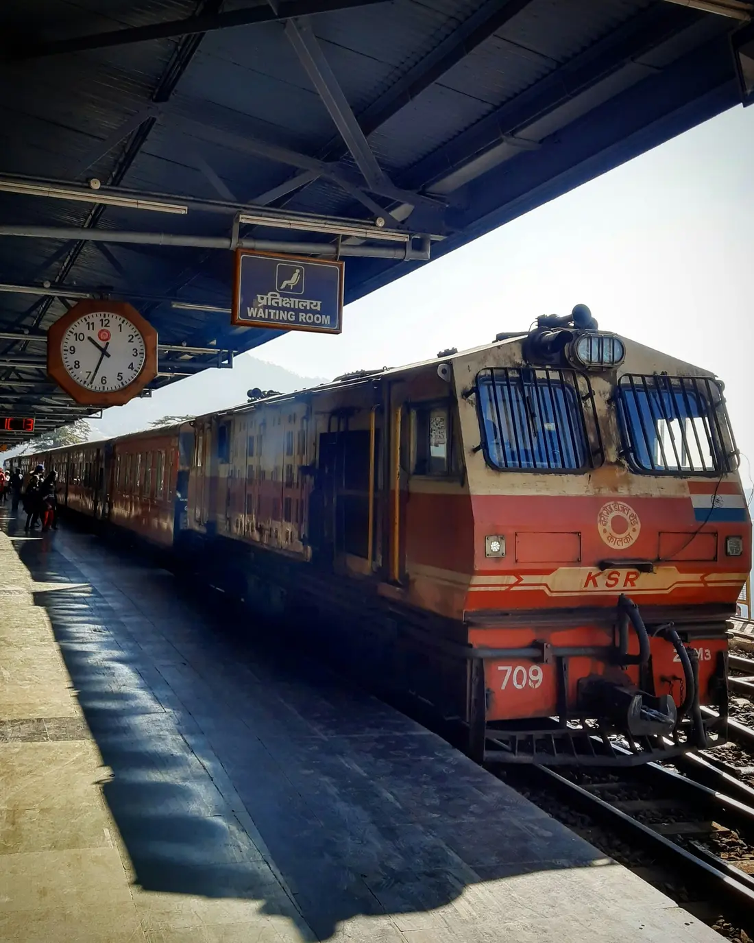 A toy train locomotive waiting at a station platform
